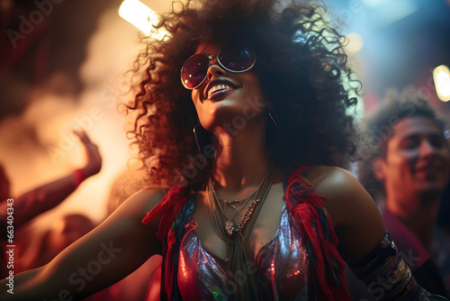 Young cheerful stylish afro woman having fun dancing in a disco
