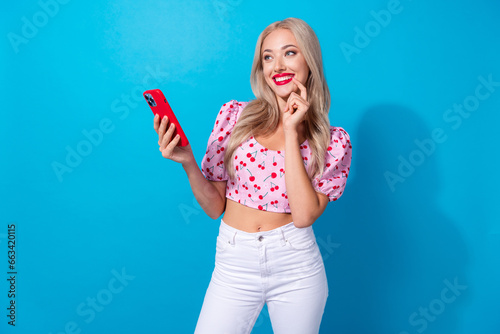 Photo of pretty young girl instagram twitter facebook telegram wear trendy pink cherry print clothes isolated on blue color background