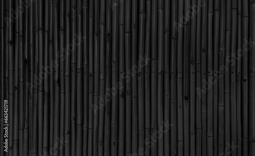 architectural dark black bamboo wall for japanese mood decoration, interior or exterior design. black bamboo plank fence texture used as background with blank space for design. © WONGSAKORN