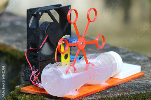 Bubble blower machine made at home using DC fan and 3D printed bubble generator dipped on a soap liquid and run by a servo photo