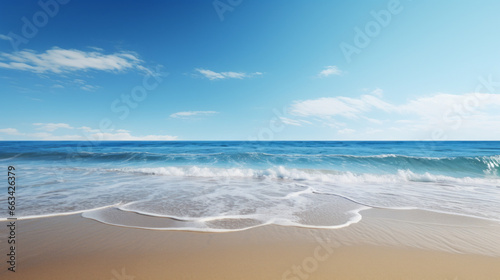 A bright, sunny beach stretches out before you, with rolling waves crashing onto the shore The sky is a deep, brilliant blue, and the sun is shining brightly