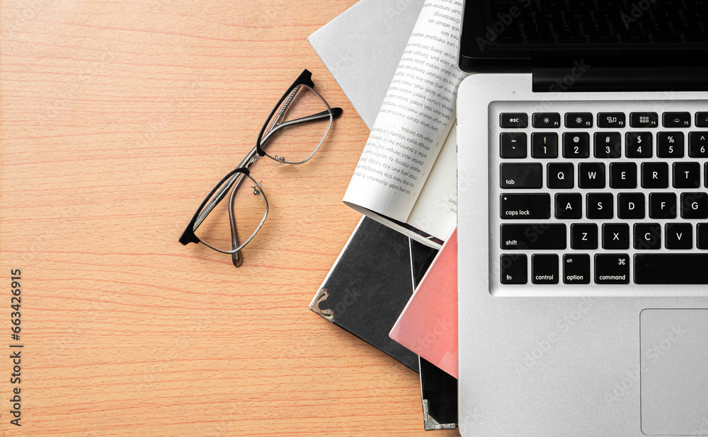 Creative Creativity Web Design desk with books, laptop and glasses on wooden background Creative Creativity Web Design desk with books, laptop and glasses on wooden background
