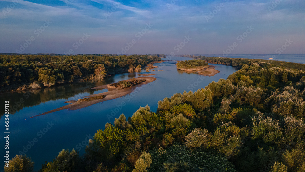 Aerial view over Danube river near Bratislava, Slovakia. The Photography was shoot from a drone at a higher altitude above the river in the morning at sunrise.