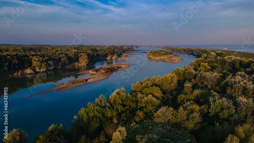 Aerial view over Danube river near Bratislava, Slovakia. The Photography was shoot from a drone at a higher altitude above the river in the morning at sunrise.