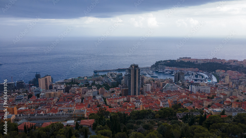 Aerial view over the city of Monaco, Monte Carlo. Photography was shoot from a drone at a higher altitude from above the city with the marina and sky scrapeprs on a stormy weather.