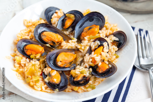Close up of rice with mussels cooked with some vegetables