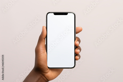 mock up a hand holding a smartphone with a blank screen. This image can be used for a variety of purposes, such as web design, graphic design, and digital marketing. photo