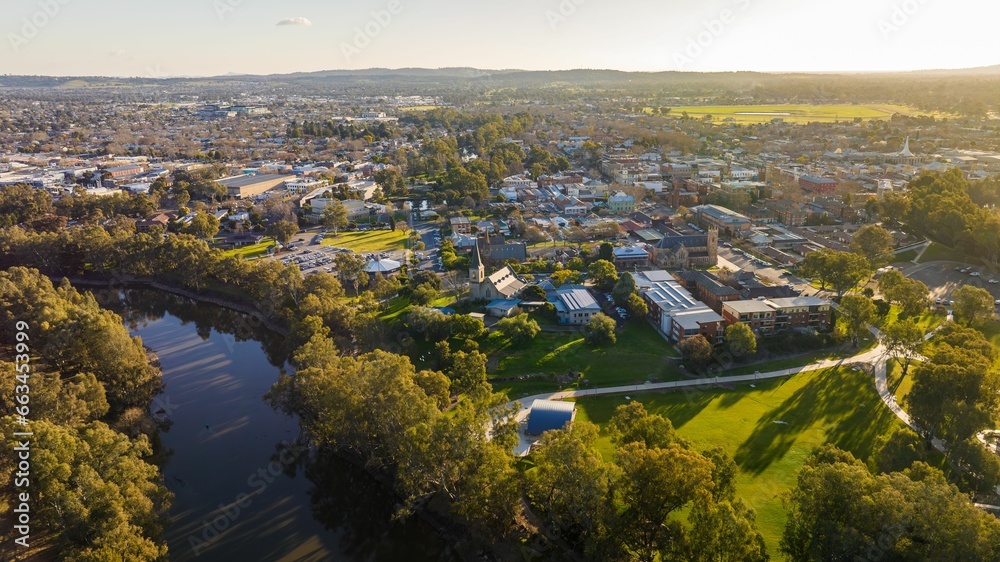an aerial of a city and a lake with trees in the foreground, Wagga Wagga