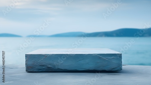 Square Stone Podium in cyan Colors in front of a blurred Seascape. Luxury Backdrop for Product Presentation