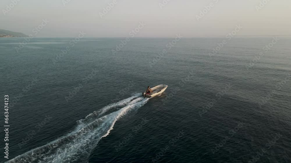 Aerial view of Fisherman on a small boat along the coast of Calabria in Diamante, Italy