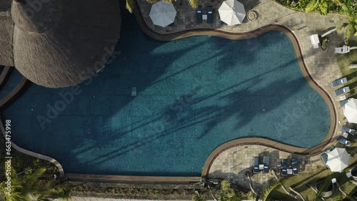 Flacq, Mauritius - 12 October 2022: Aerial view of a swimming pool of a luxury resort with palm trees along the coastline, Ilot Lievres. photo