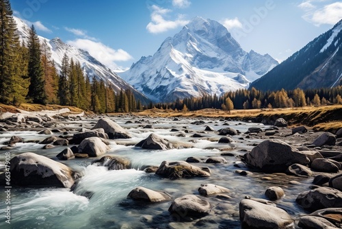 Fast-moving river framed by snowy mountain peaks in the distance