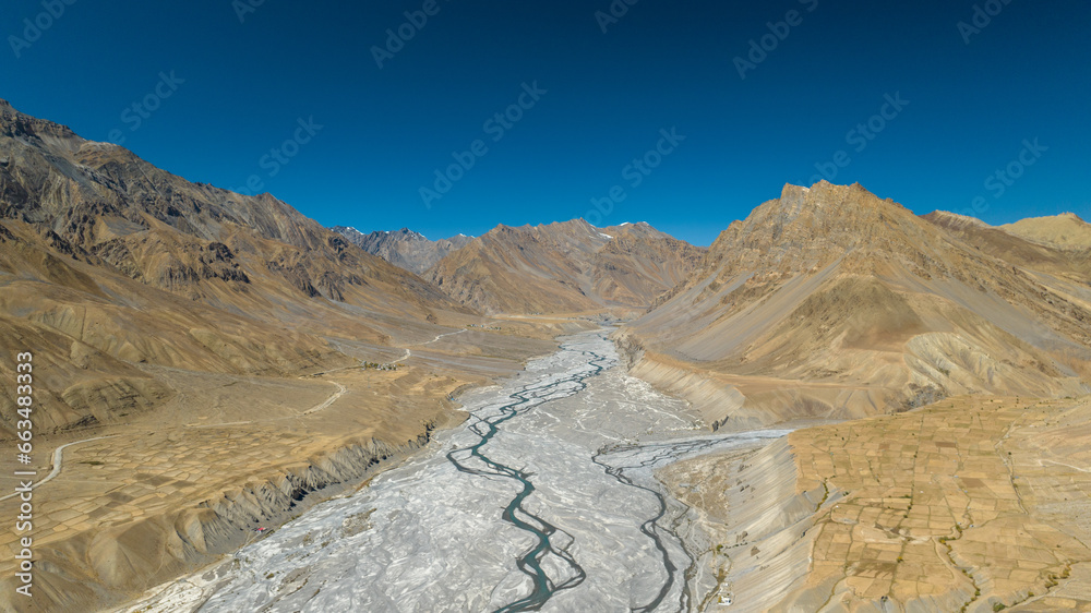 Aerial landscape of a river bed in cold desert mountains