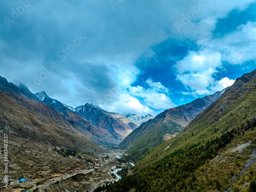 Aerial landscape with clouds  mountains and snowcapped peaks