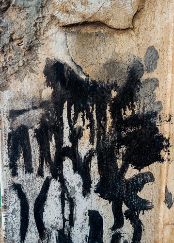 Abstract paint grunge background. Drty old cement wall with black paint stains  photo