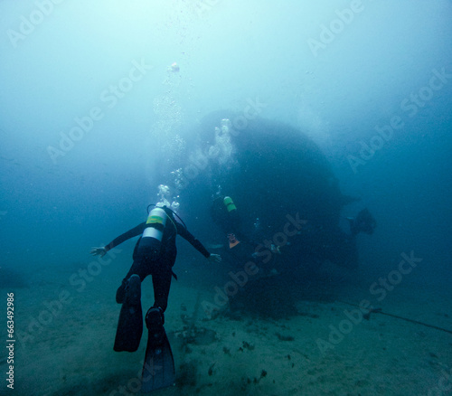 diver and sunken ship in the background © Juan Martínez 