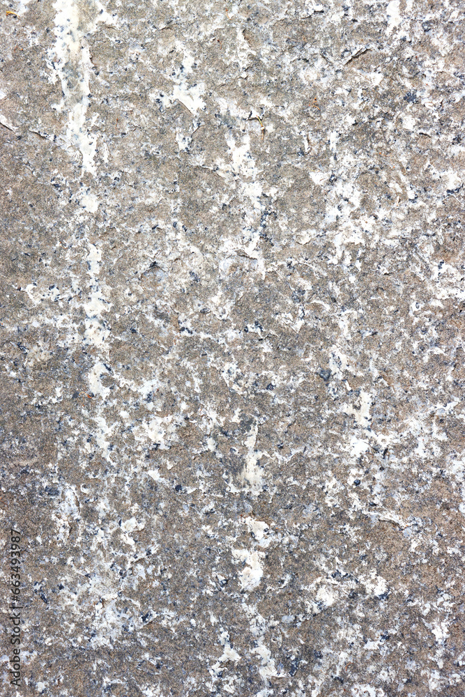 Obraz premium Vertical photo of an old, gray, concrete wall damaged by time.