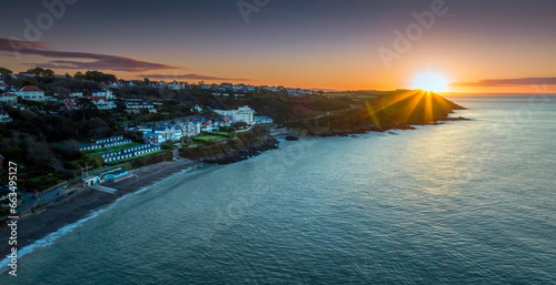 Editorial SWANSEA, UK - OCTOBER 15, 2023: Sunrise over Langland Bay and Rotherslade Bay on the peninsula in Swansea, South Wales, UK. 