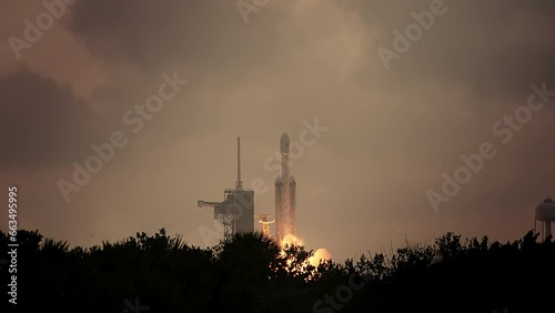 Spectacular shot of a Space Rocket blasting off from launch pad as it flies to space on its mission to psyche asteroid.  4K. Slow-motion. Includes sound and audio.