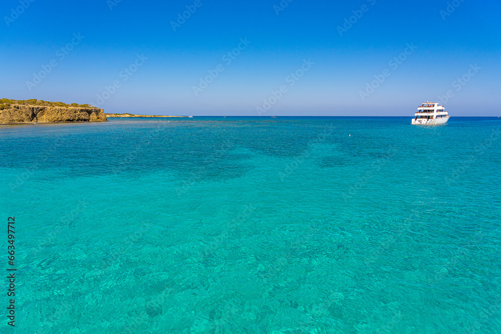 Blue lagoon with tourist boats at a moment of relaxation, Polis, Cyprus. September 2023