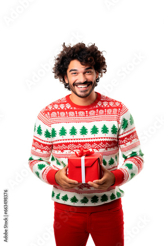 Latin American man wearing ugly Christmas sweater holding gift box over isolated transparent background