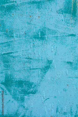 the concrete wall is rough painted in blue and light blue
