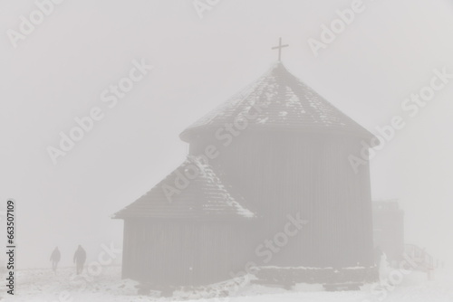 Church in the snow in the fog on the top of Mount Śnieżka in the Karkonosze massif in Lower Silesia. Polish winter
