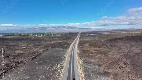 Aerial volcanic lava flow highway Kona Hawaii pull 1. Big Island Kilauea and Maunaloa volcanos are the most active on earth. Economy is tourism. Tropical beach, nature, rainforest, desert recreation. photo