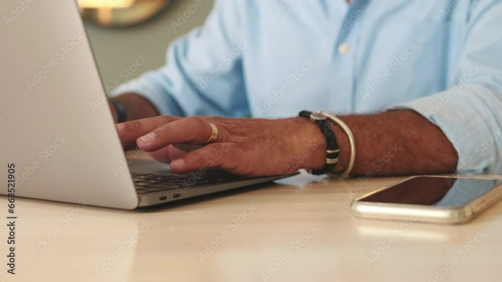 Close-up of hands of an unrecognizable elderly man working on laptop
