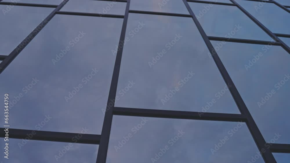 Building glass facade reflects sky. Fantastic modern skyscraper combines skill of creators and beauty of nature through mix of colors Building glass facade reflects sky. Fantastic modern skyscraper combines skill of creators and beauty of nature through mix of colors