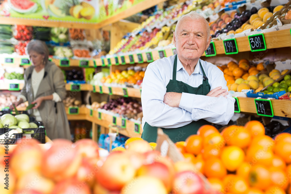 Portrait of an elderly supermarket worker in a sales floor