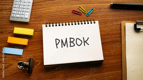 There is notebook with the word PMBOK. It is as an eye-catching image.
