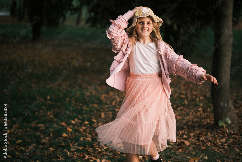 A happy joyful girl in the autumn park.