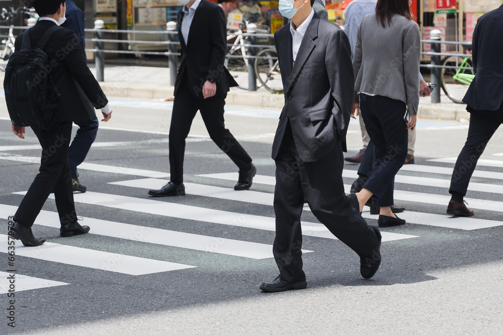 businessmen crossing a street in Tokyo, Japan