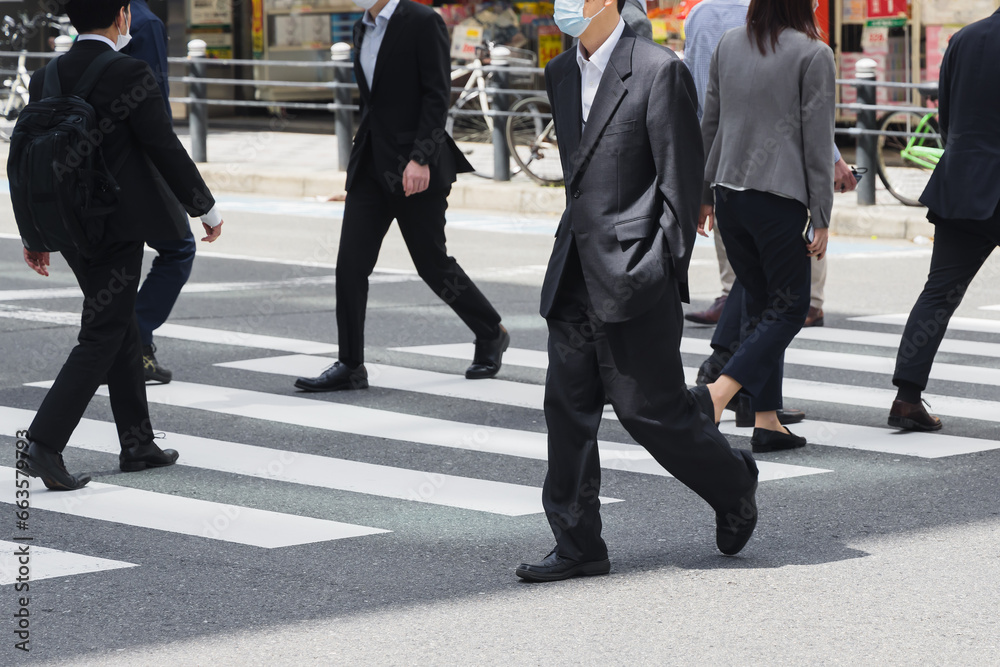 businessmen crossing a street in Tokyo, Japan businessmen crossing a street in Tokyo, Japan
