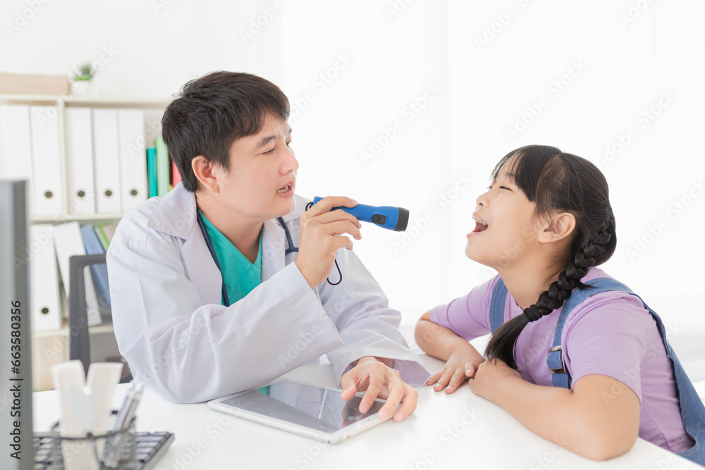 asian doctor use flashlight and diagnosis children patient in hospital, children open her mount and show her tongue, child clinical screening, happiness hospital asian doctor use flashlight and diagnosis children patient in hospital, children open her mount and show her tongue, child clinical screening, happiness hospital
