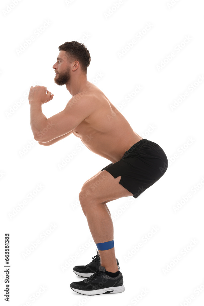 Young man exercising with elastic resistance band on white background Young man exercising with elastic resistance band on white background