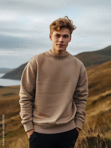Sweatshirt Mockup one young man guy boy in a tan blank crewneck outside in the autumn fall hills over the ocean sea