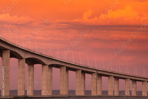 Fototapeta Naklejka Na Ścianę i Meble -  Suspension bridge on the background of beautiful sky at sunset.