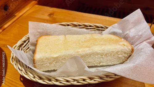 bread and butter Toasted bread with garlic butter in a basket on a wooden table