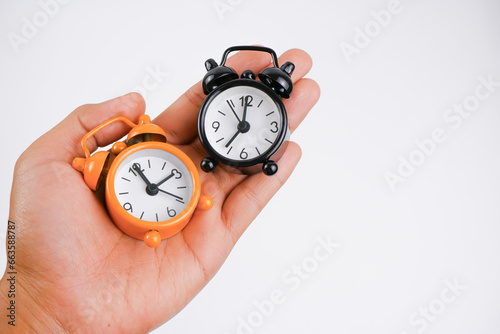 A man hold a clocks.