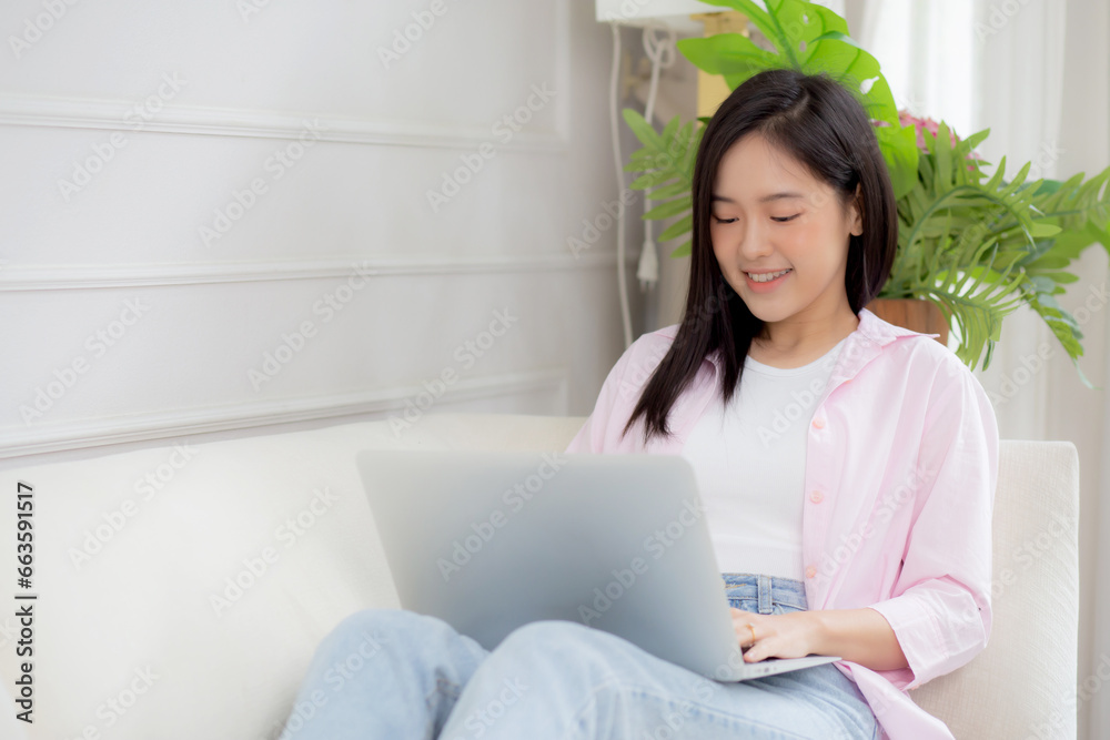 Young asian business woman work from home with laptop computer online to internet on sofa in living room, freelance girl using notebook sitting on couch with comfort and relax, lifestyles concept. Young asian business woman work from home with laptop computer online to internet on sofa in living room, freelance girl using notebook sitting on couch with comfort and relax, lifestyles concept.