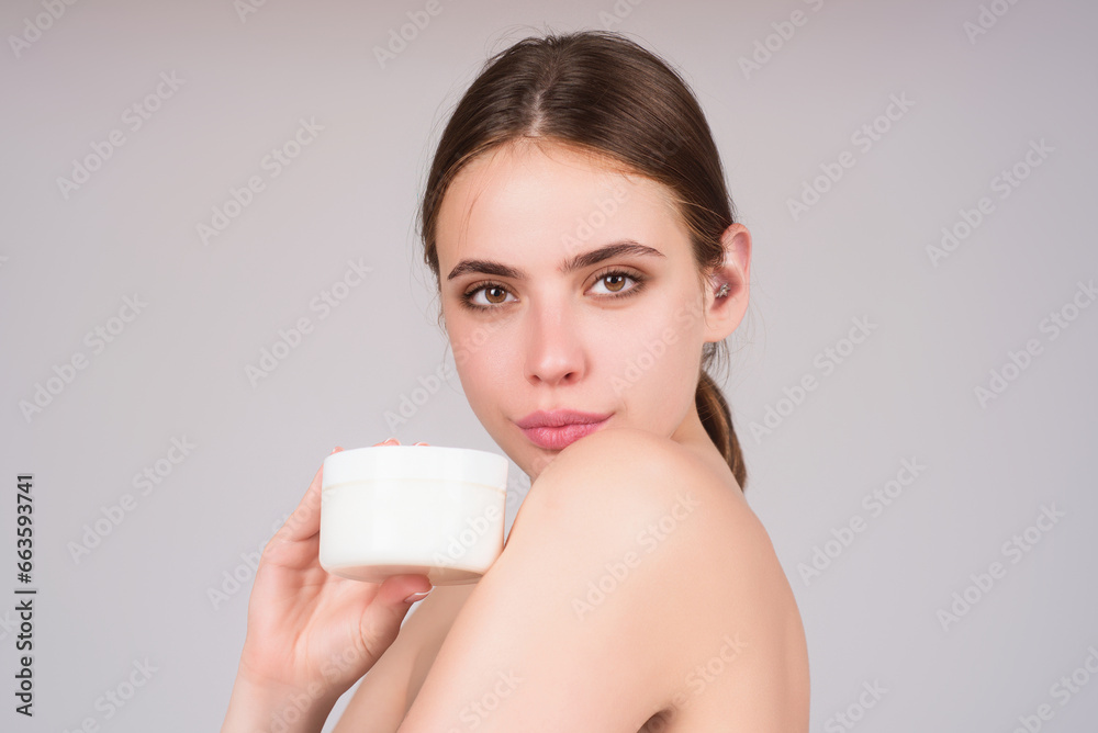 Skin care. Woman applying face cream, studio portrait. Beautiful model with moisturizing cream anti age cream on perfect soft skin. Beauty cosmetic product industry. Skin care. Woman applying face cream, studio portrait. Beautiful model with moisturizing cream anti age cream on perfect soft skin. Beauty cosmetic product industry.