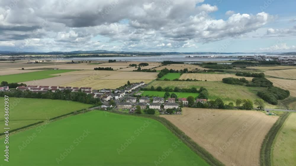 4K Aerial orbit over Scottish Country Town just outside of Edinburgh, The Capital of Scotland, United Kingdom. The North Sea inlet in the background.