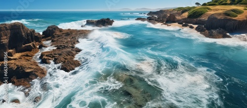 Aerial panoramic view of ocean waves crashing on the rocky shore