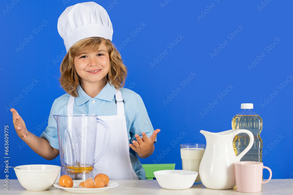 Child chef isolated on blue. Funny little kid chef cook wearing uniform cook cap and apron cooked food in the kitchen. Child chef isolated on blue. Funny little kid chef cook wearing uniform cook cap and apron cooked food in the kitchen.