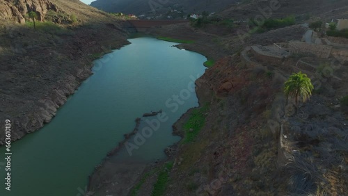 Ayagaures dam, Gran Canaria: aerial view traveling in the retaining wall of the dam on a sunny day. photo