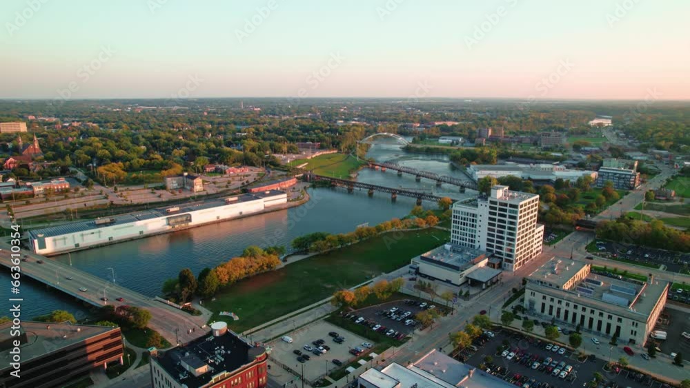 orbiting aerial at sunet towards Rock River and bridges then revealing beautiful downtown Rockford Illinois from America. Cinematic panorama. orbiting aerial at sunet towards Rock River and bridges then revealing beautiful downtown Rockford Illinois from America. Cinematic panorama.