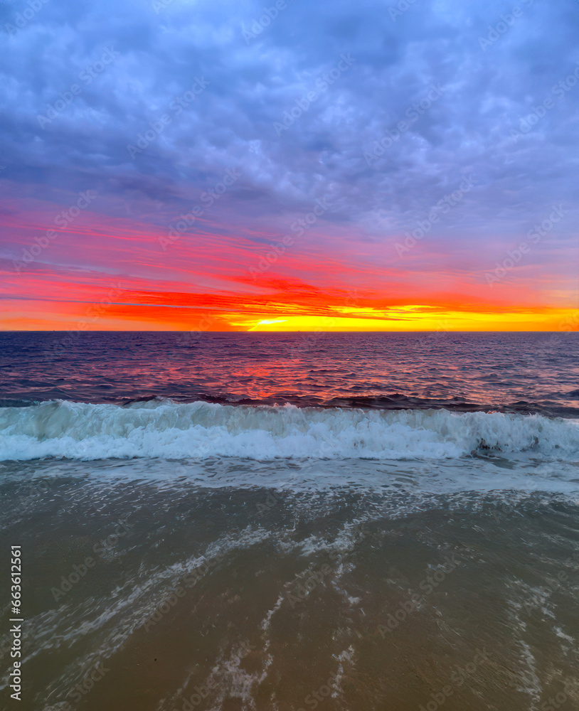 Sunrise on ocean wave at beginning of morning