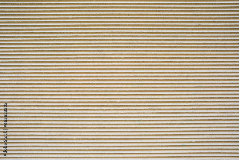 Background from a beige plastered wall with a corrugated profile Background from a beige plastered wall with a corrugated profile